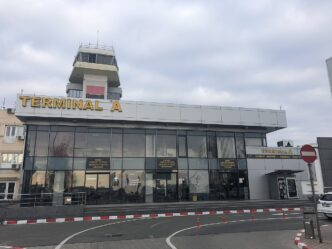 Clădirea Terminalului A și turnul de control ale aeroportului din Timișoara, într-o zi înnorată